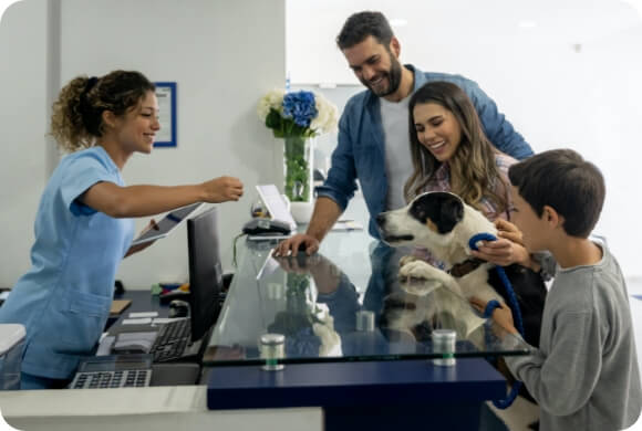 A puppy greets a vet at their office