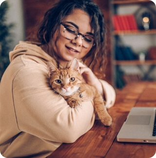 A woman holds a cat in her arms